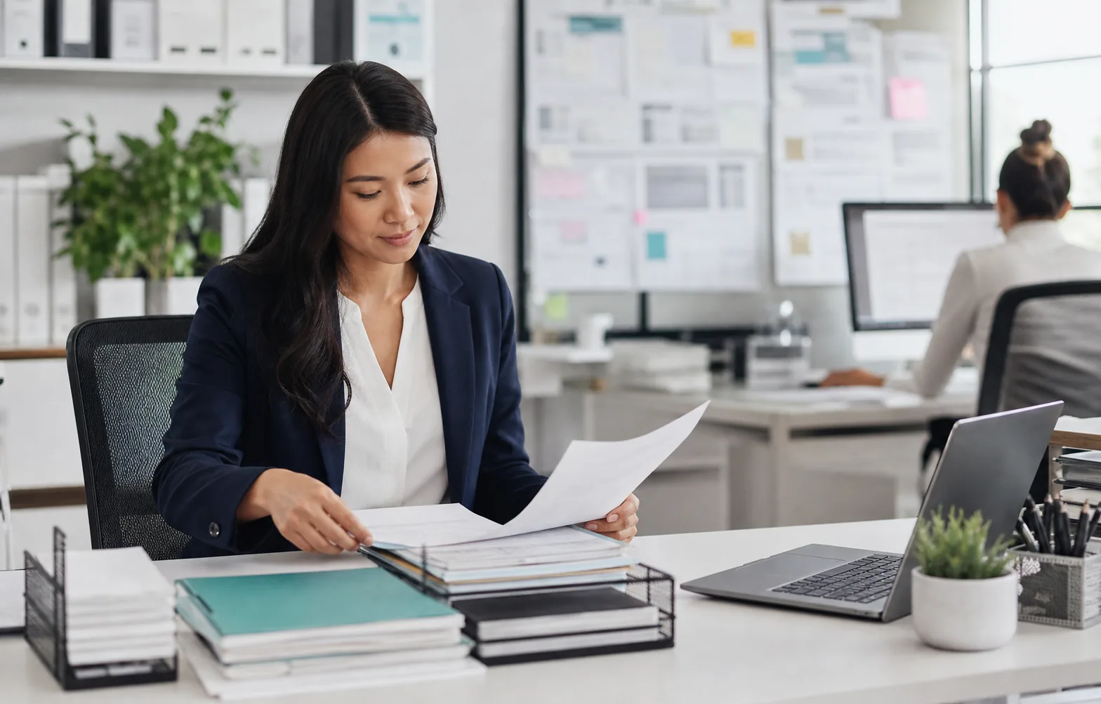 Back office operations coordinator organising documents in a modern office